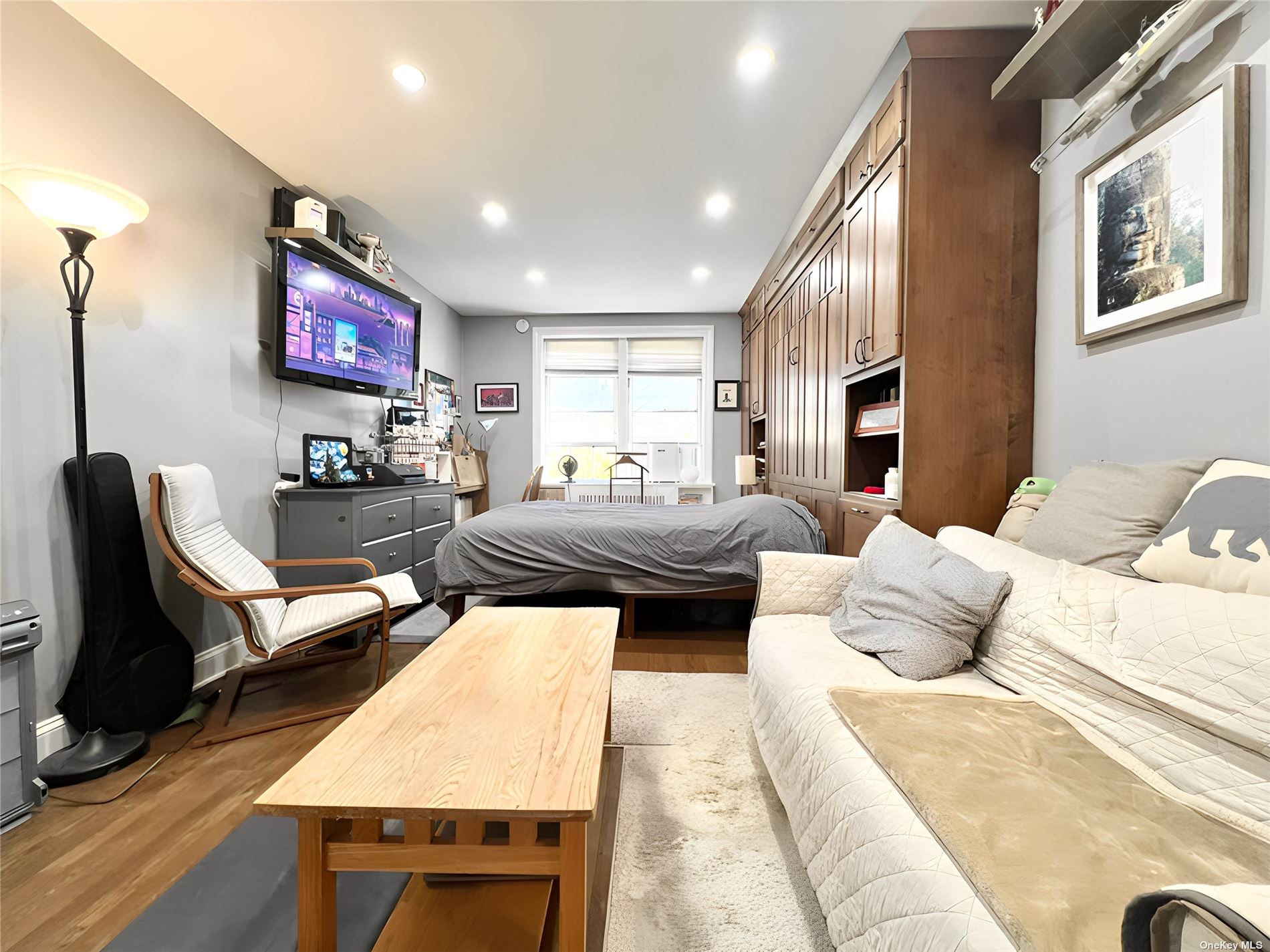 a living room with furniture rug and wooden floor