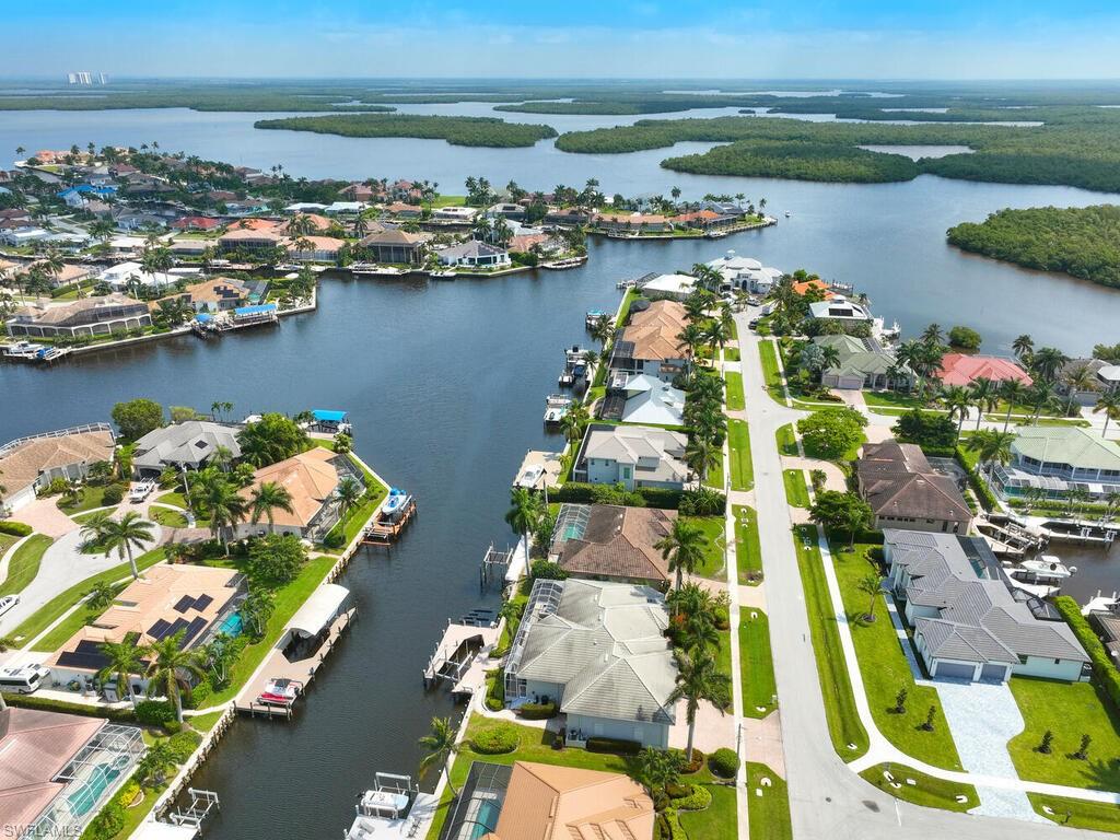 an aerial view of water body with boats and trees all around