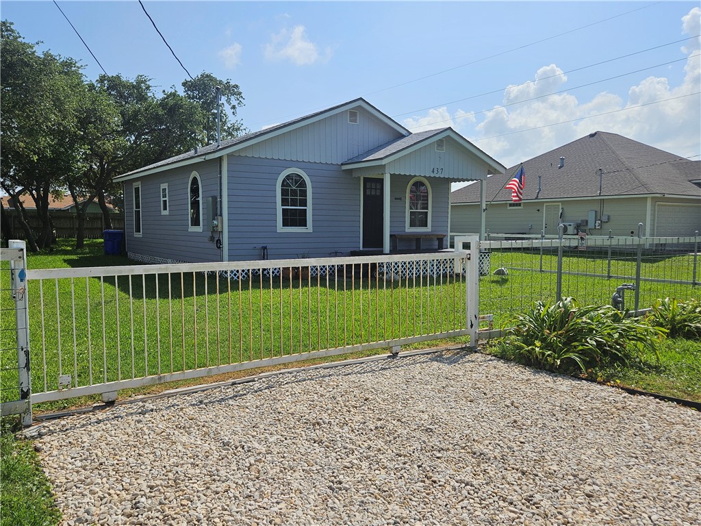 a view of a house with a yard and potted plants