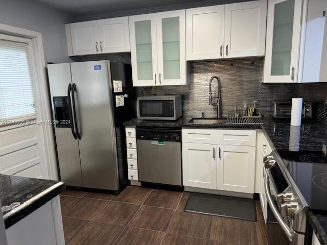 a kitchen with a refrigerator stove and sink