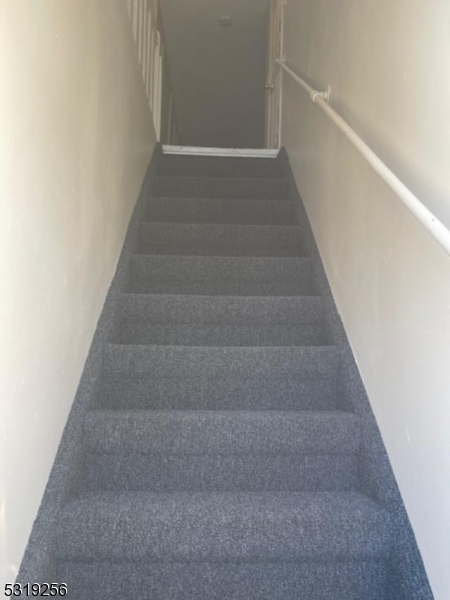 a view of staircase with white walls