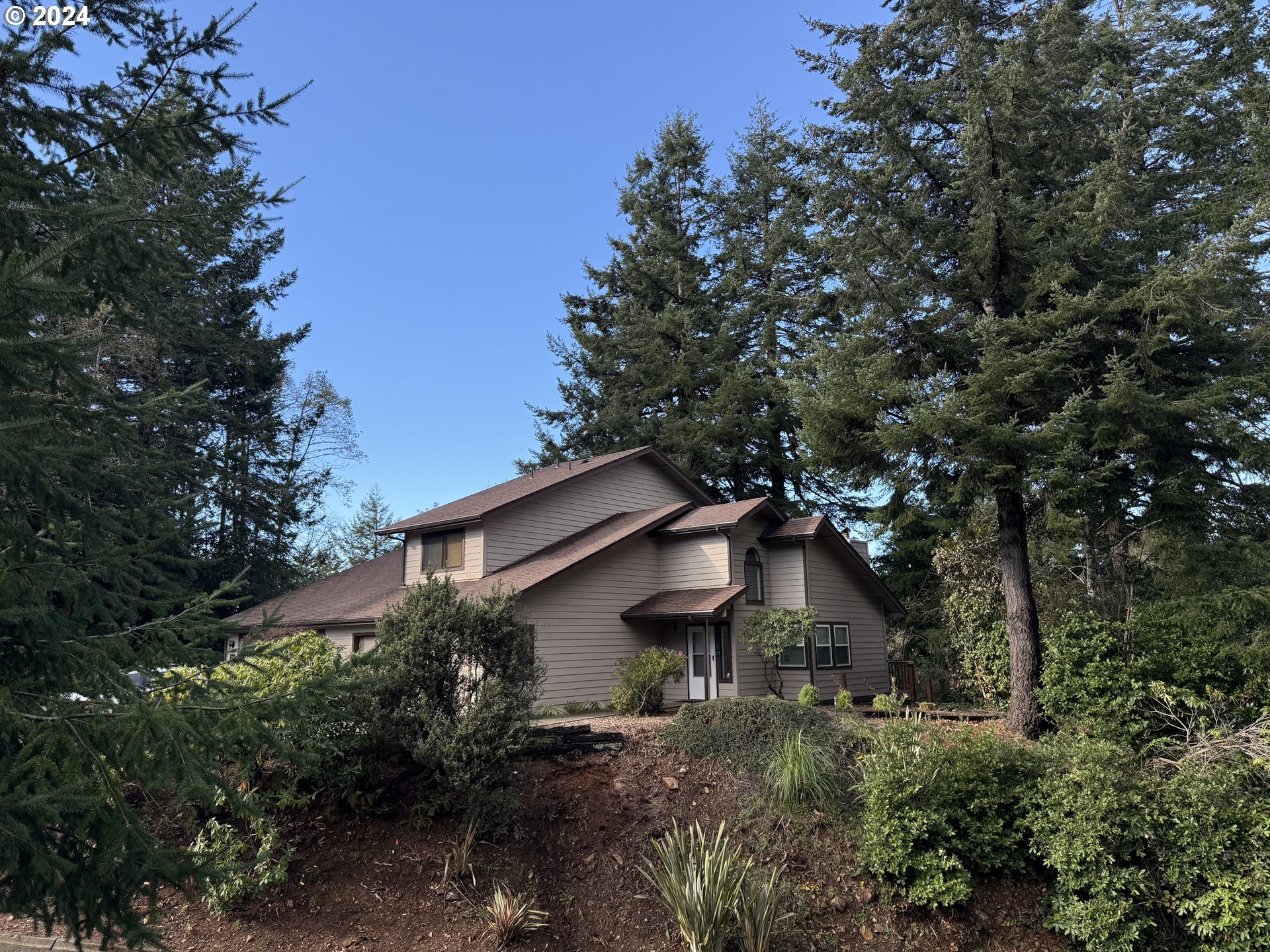 a yellow house with trees in front of it