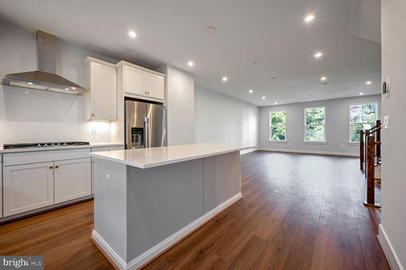 a view of kitchen with sink and wooden floor