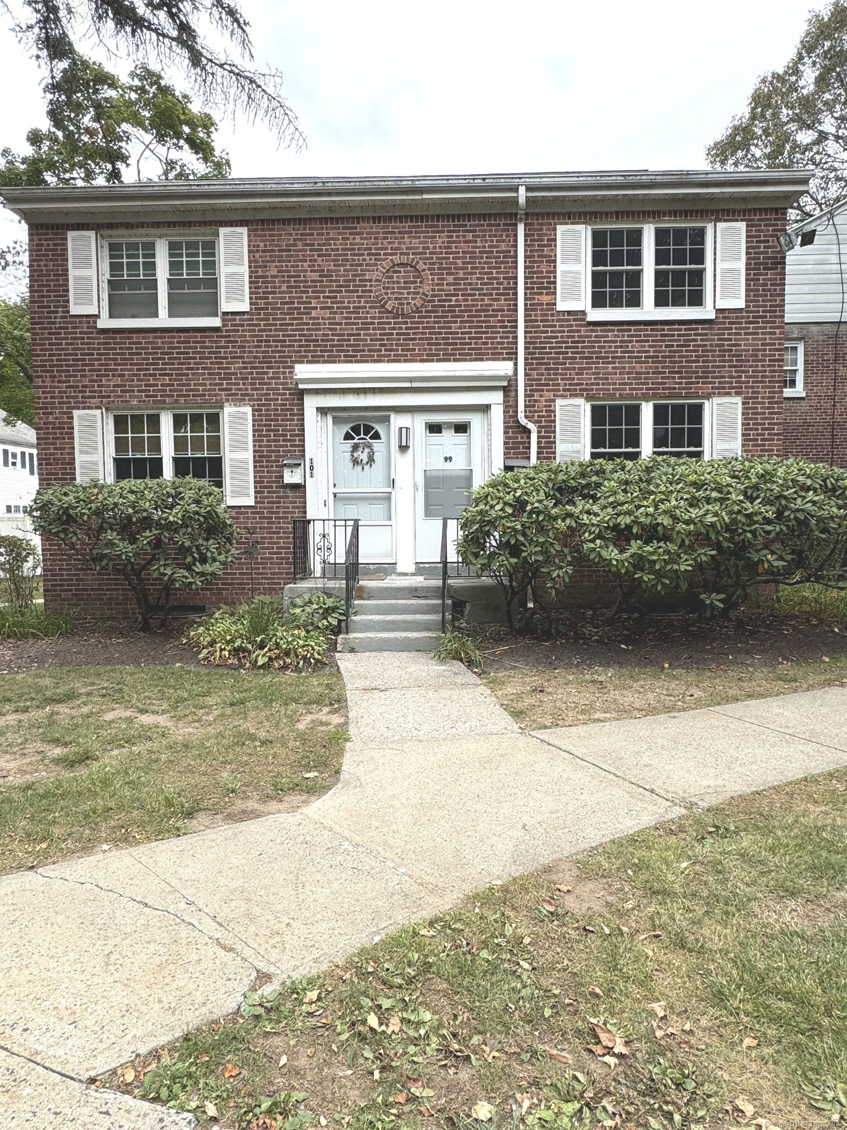 a front view of a house with garden