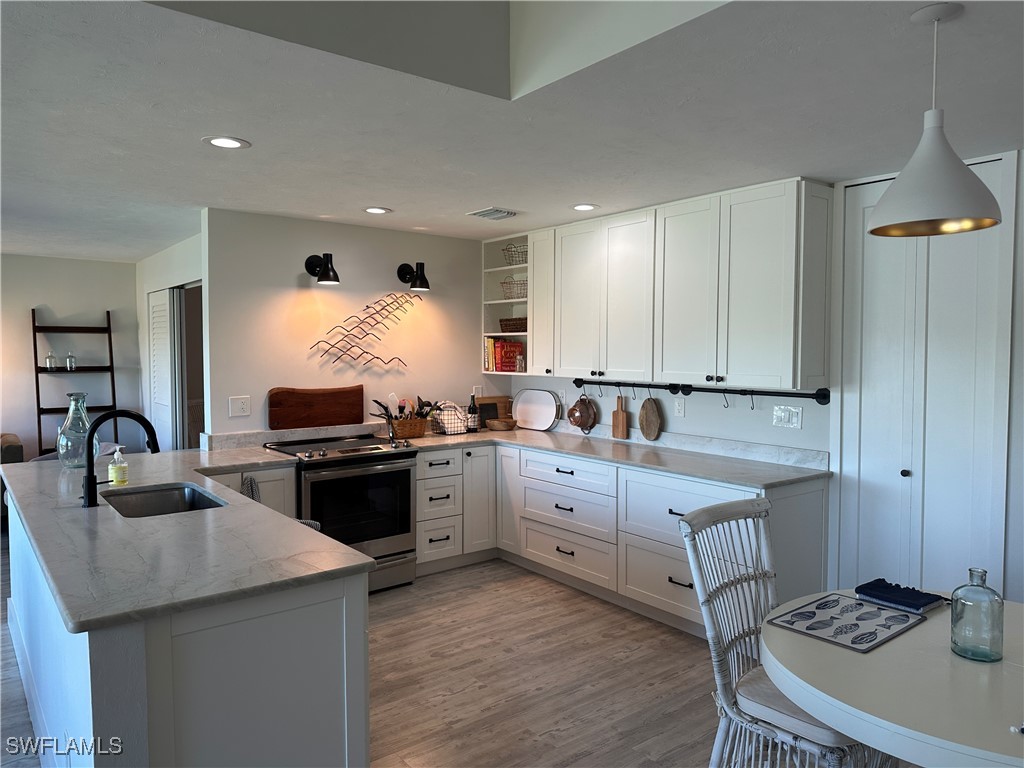 a kitchen with a sink stove and cabinets