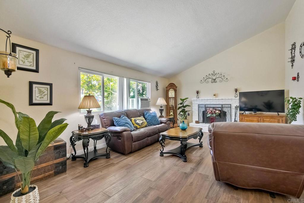 a living room with furniture a flat screen tv and a large window