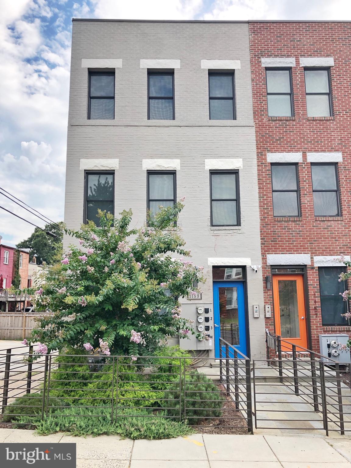 a view of a brick building next to a yard