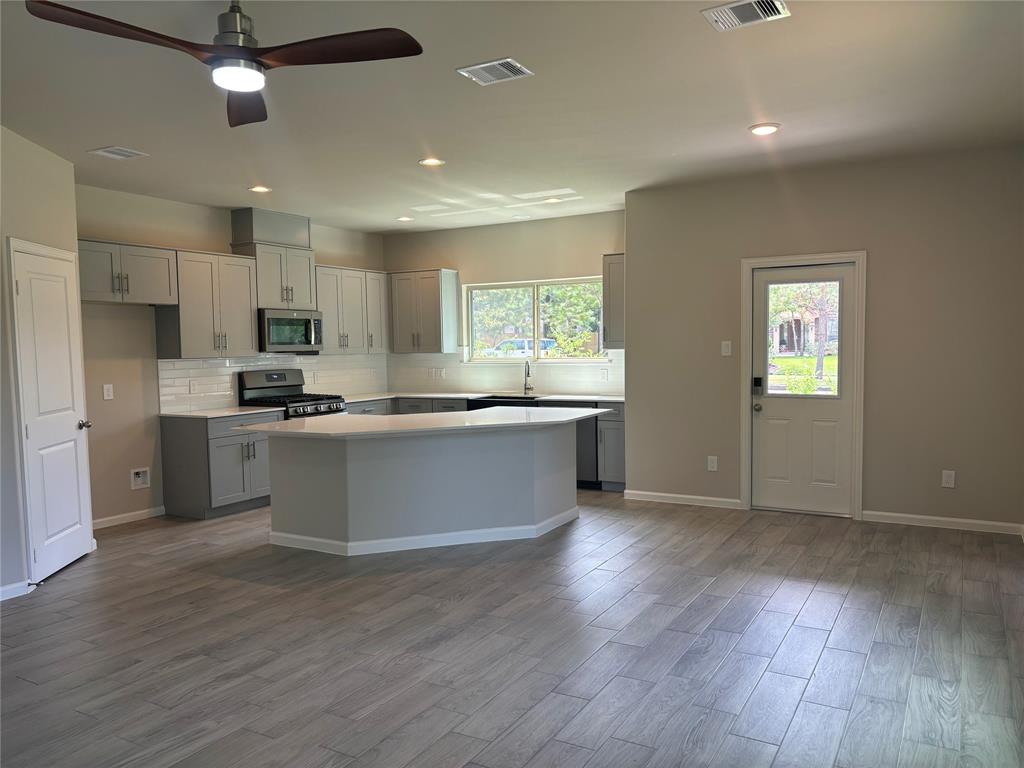 a view of kitchen with cabinets and wooden floor