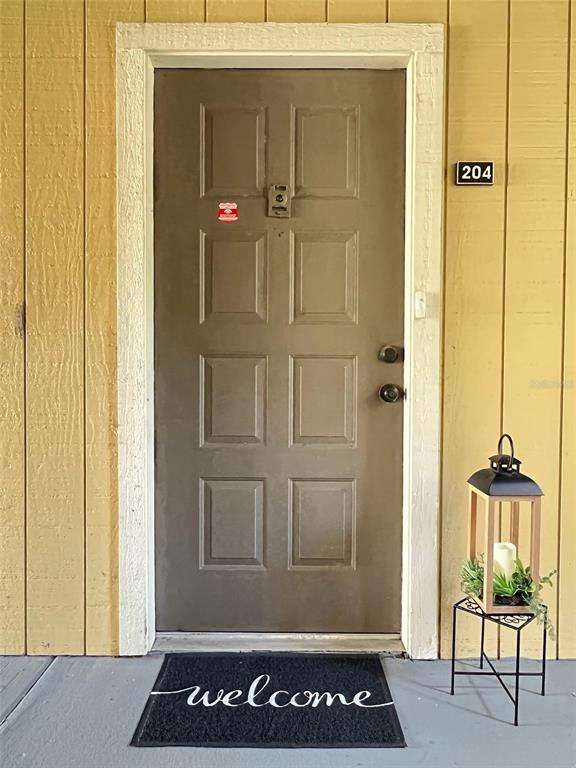 a view of a hallway with furniture and front door