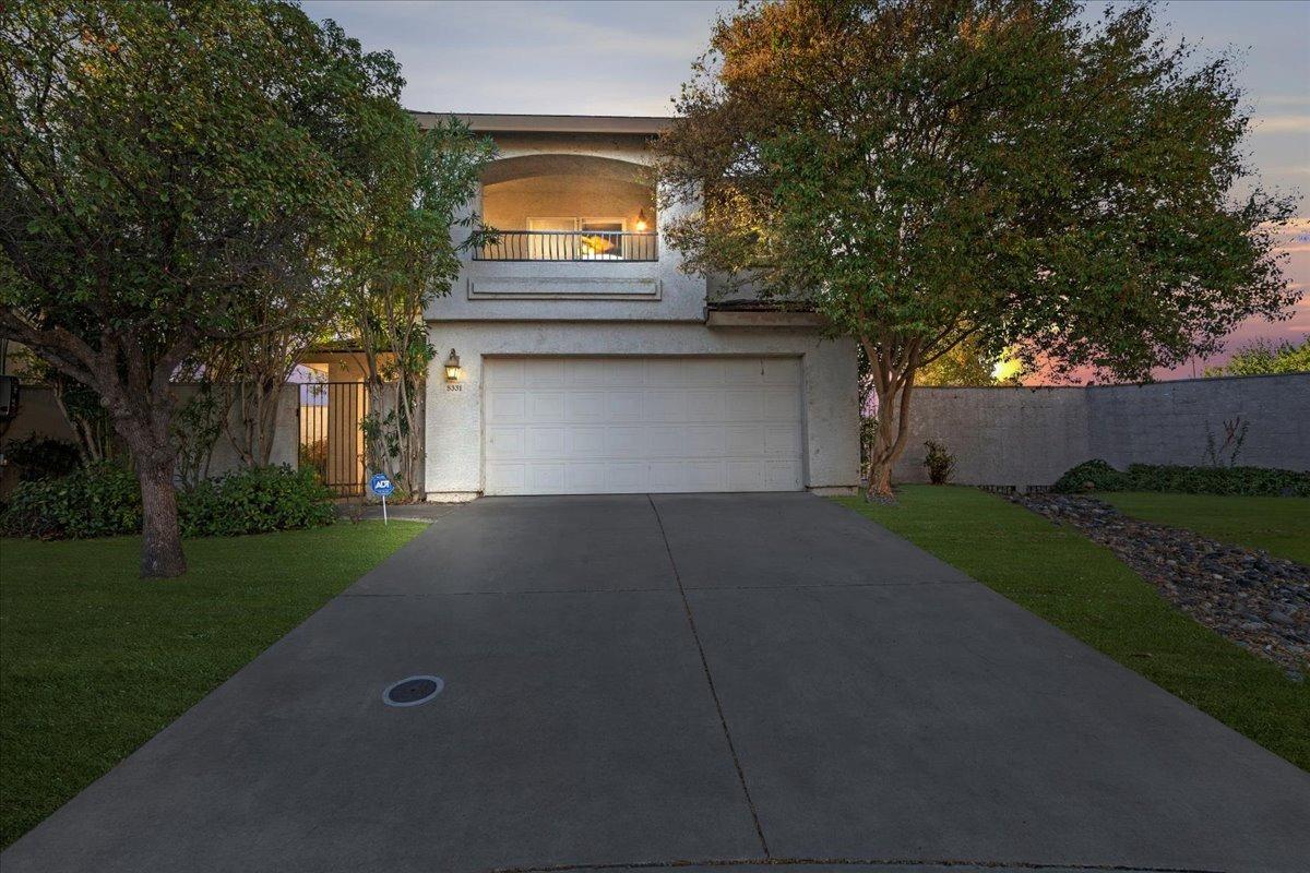 a front view of a house with a yard and garage