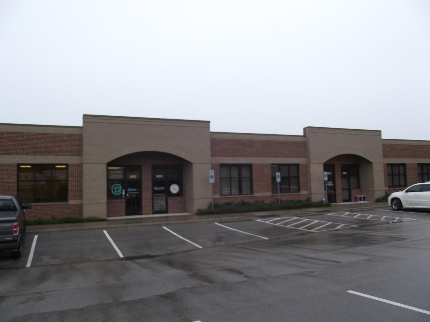 a view of building with car parked