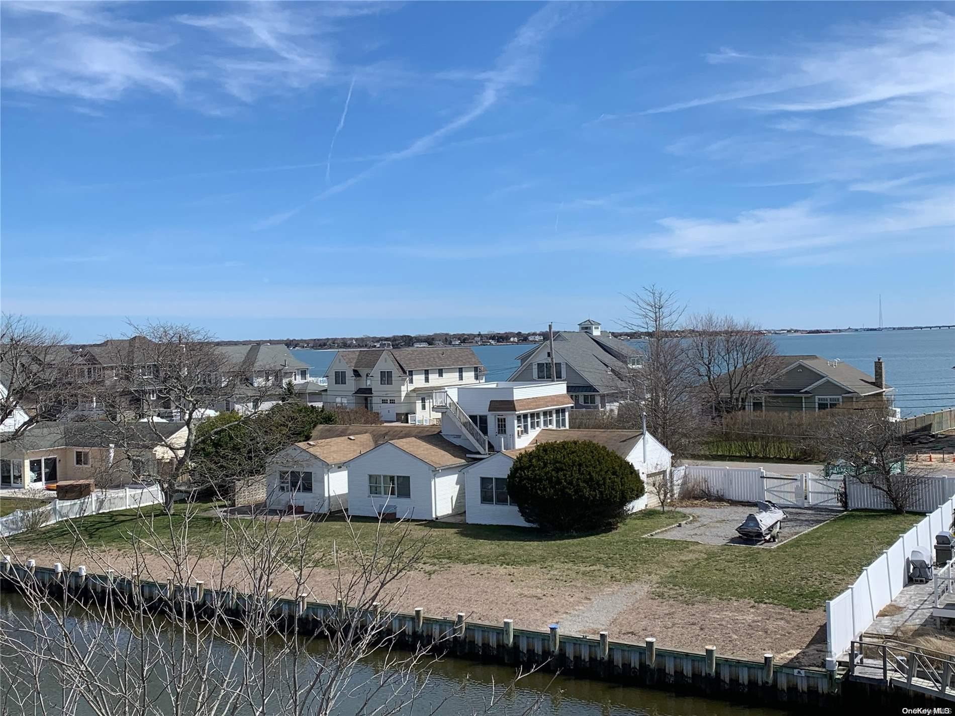 a view of a house with a yard and lake view