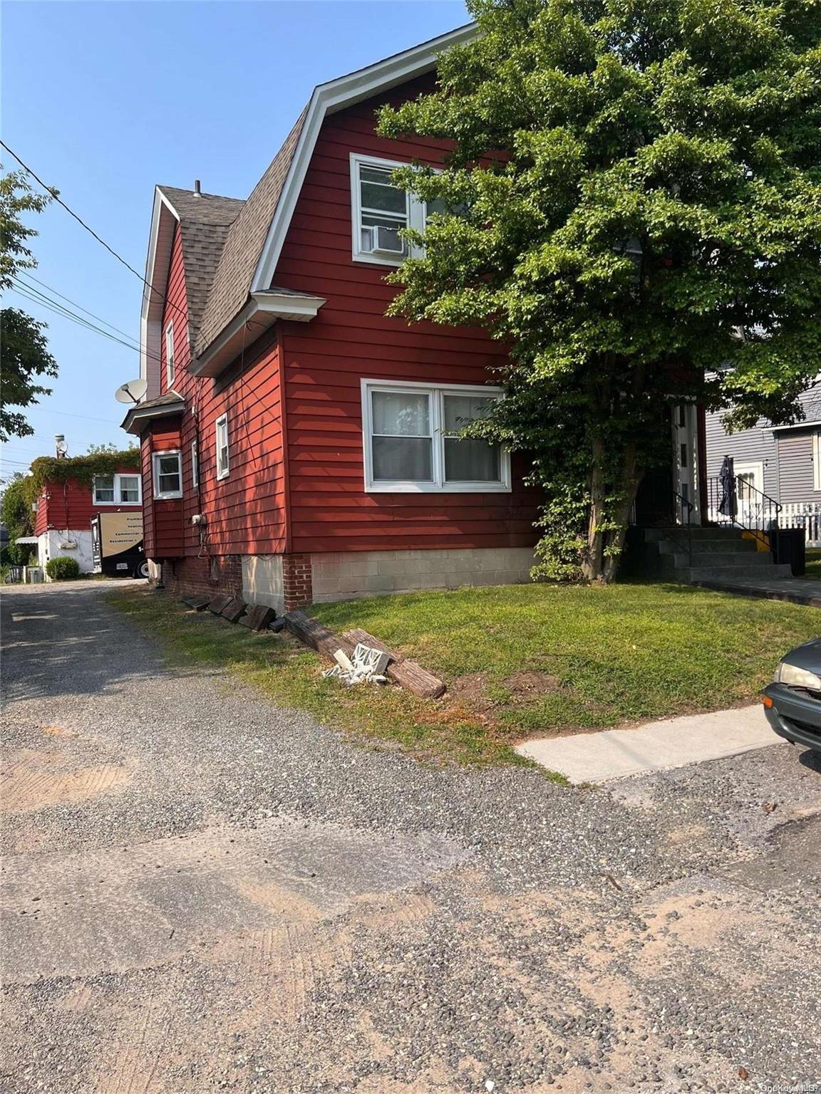 a view of a house with a yard and tree s