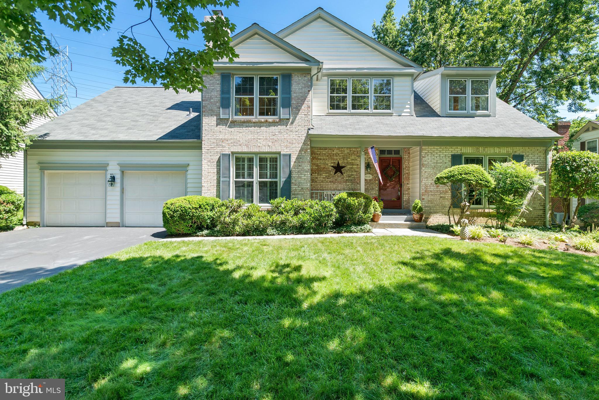 a front view of a house with a yard and porch