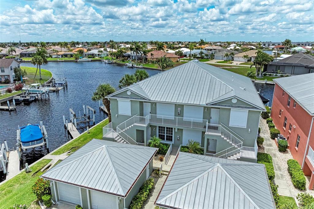 an aerial view of a house with swimming pool and ocean view