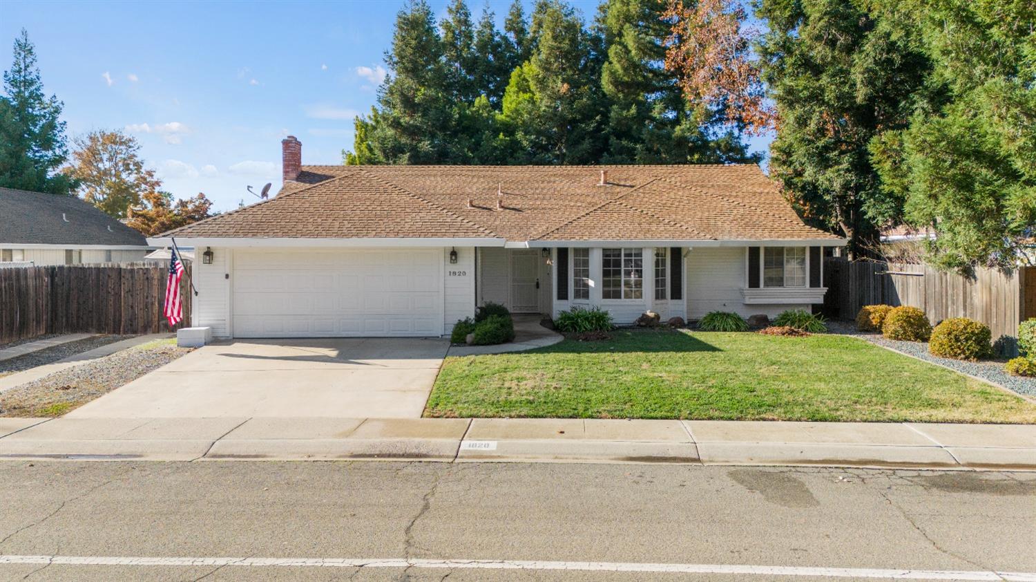 a house that has a tree in front of it