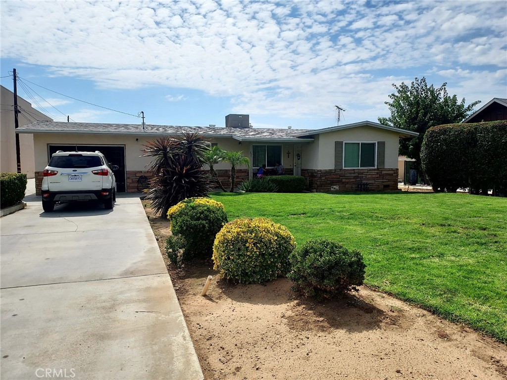 a front view of a house with a garden