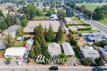 an aerial view of a house with a yard and lake view