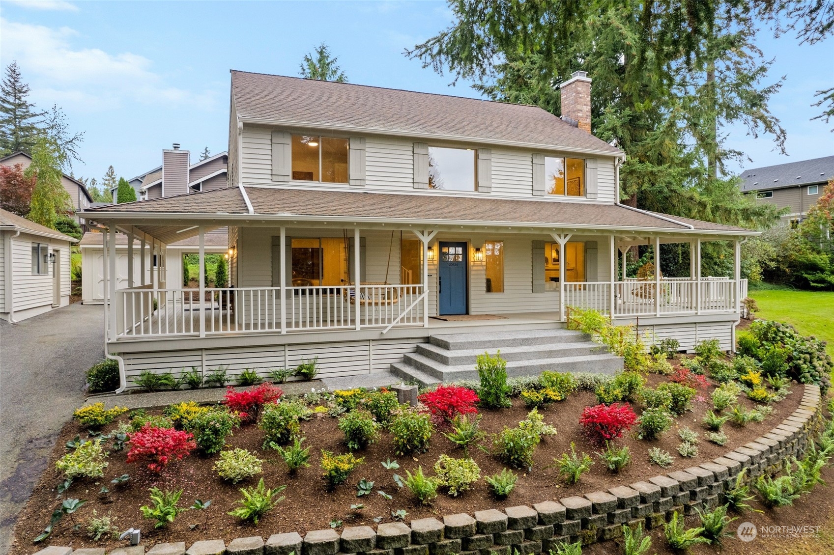 a front view of a house with a yard and fountain