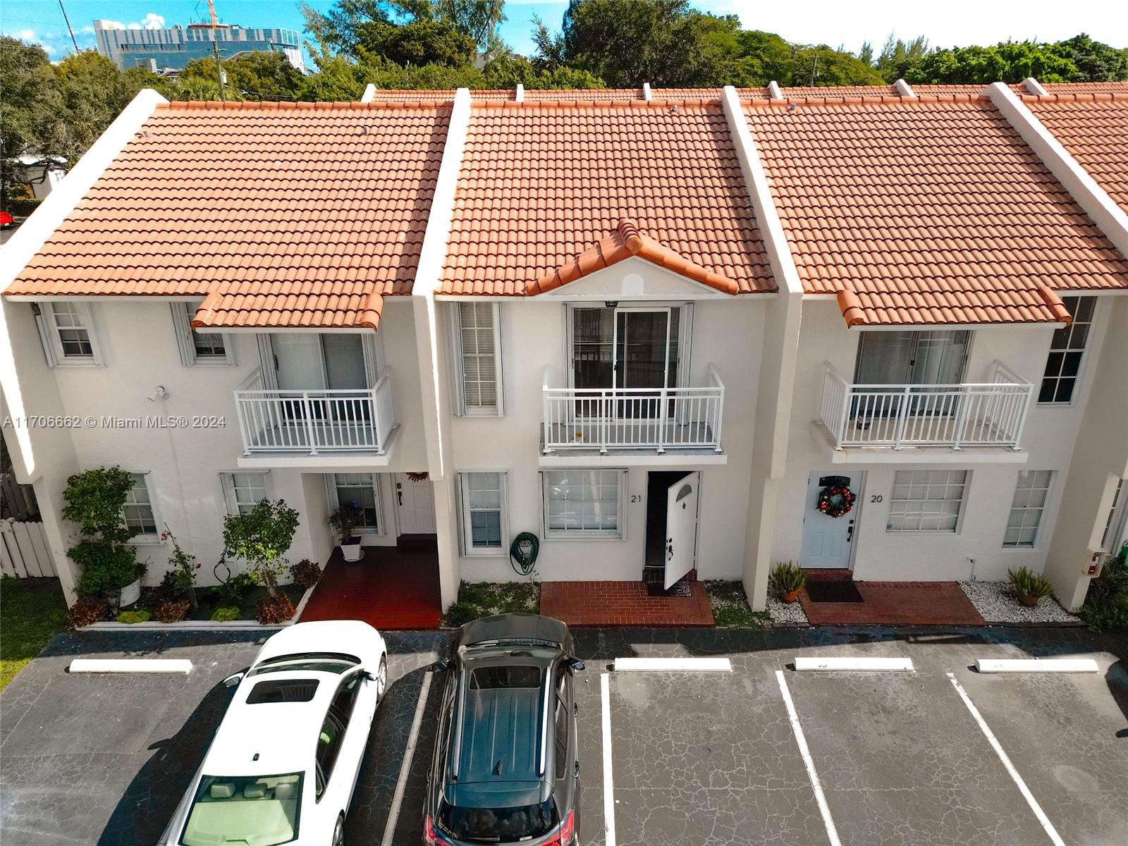 a front view of a residential apartment building with a yard