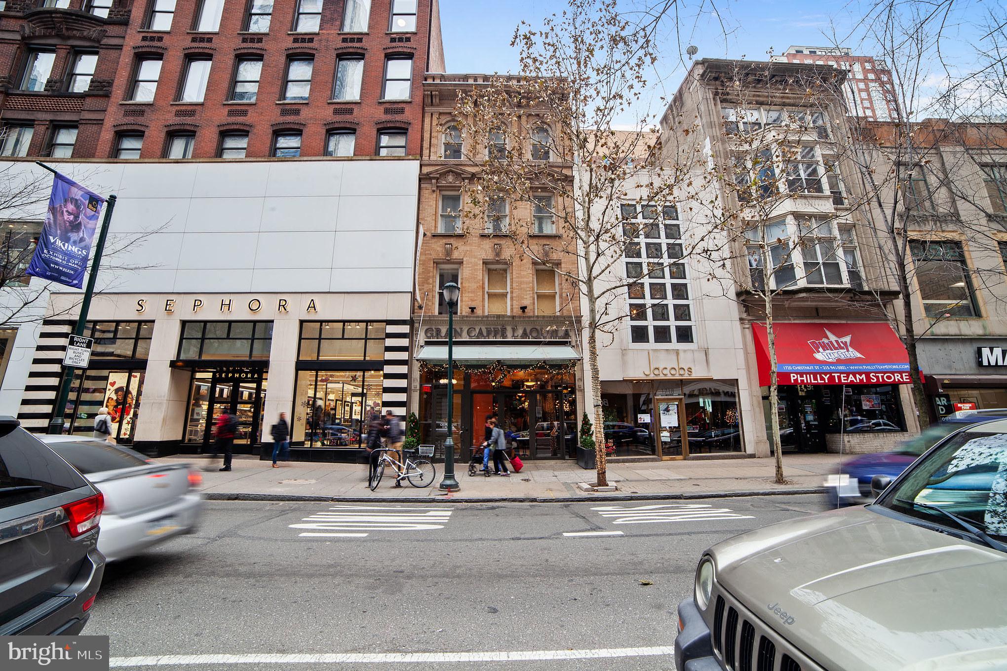 a view of a building and a people on a street