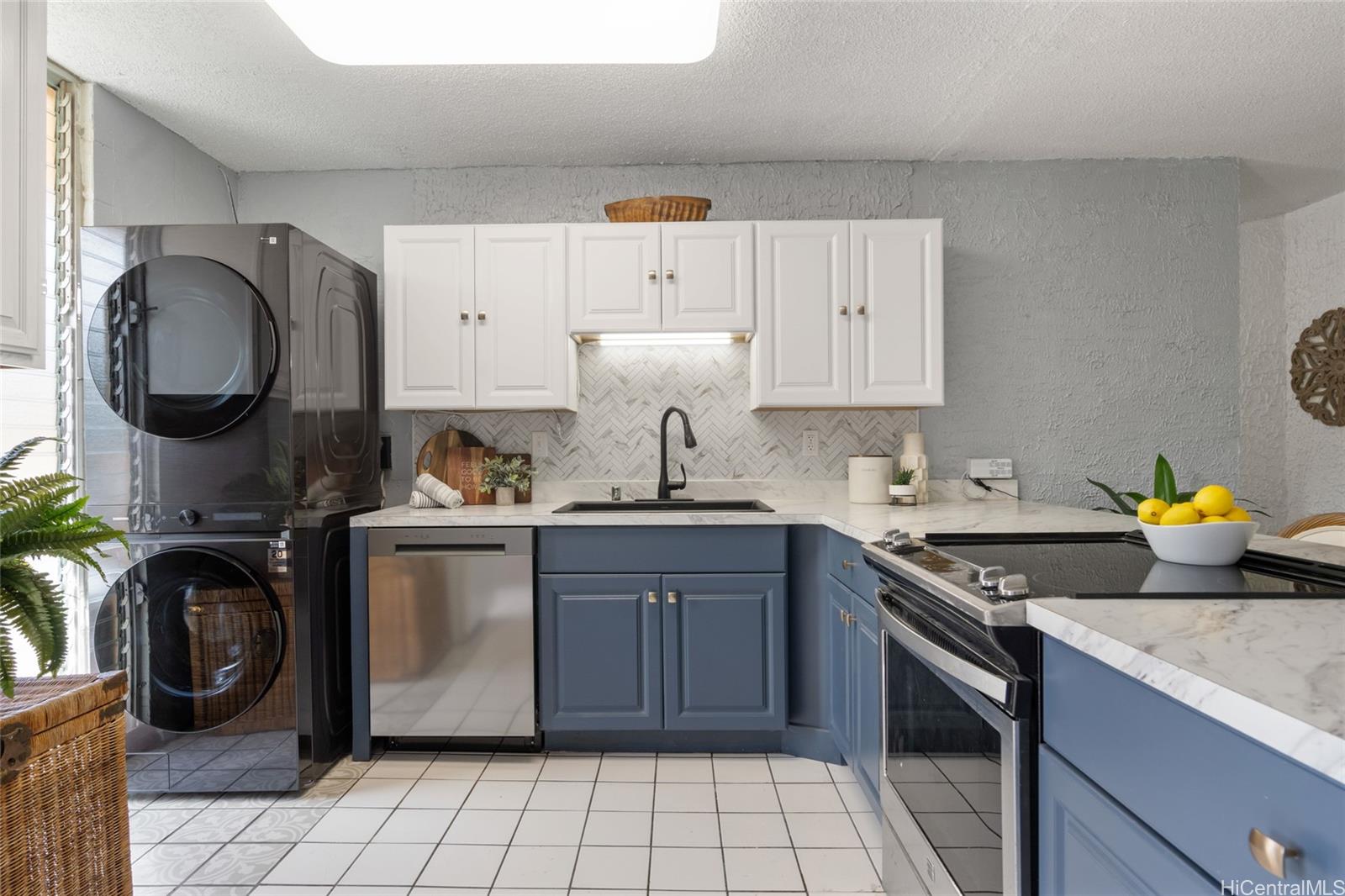 Kitchen with brand new dishwasher, washer/dryer, cabinets, counters and backsplash