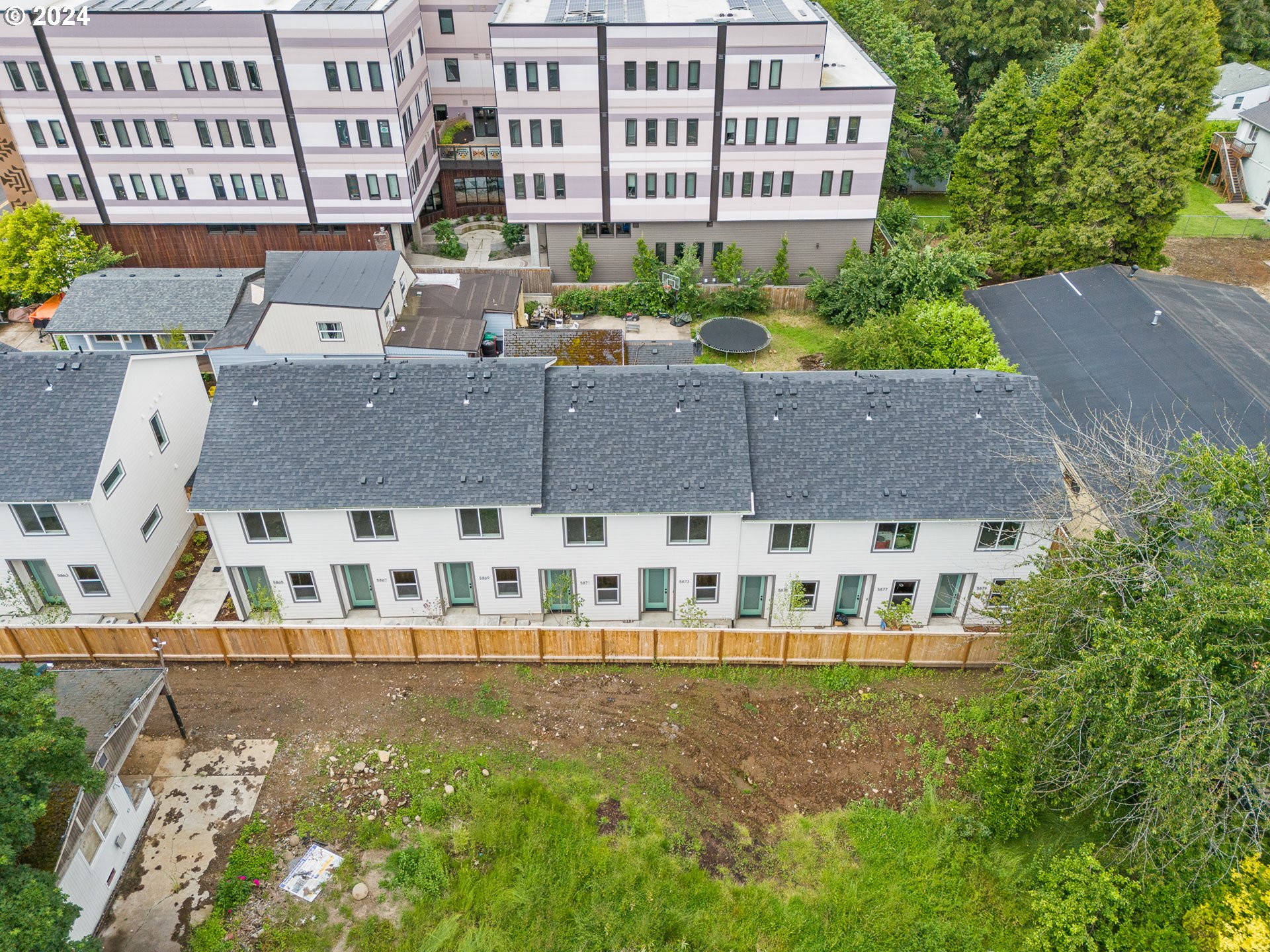 a view of building with yard in front of it