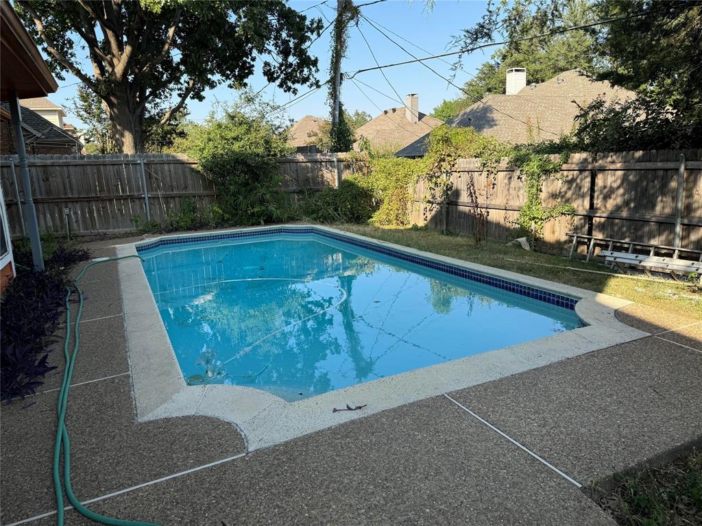 a view of a swimming pool with a patio