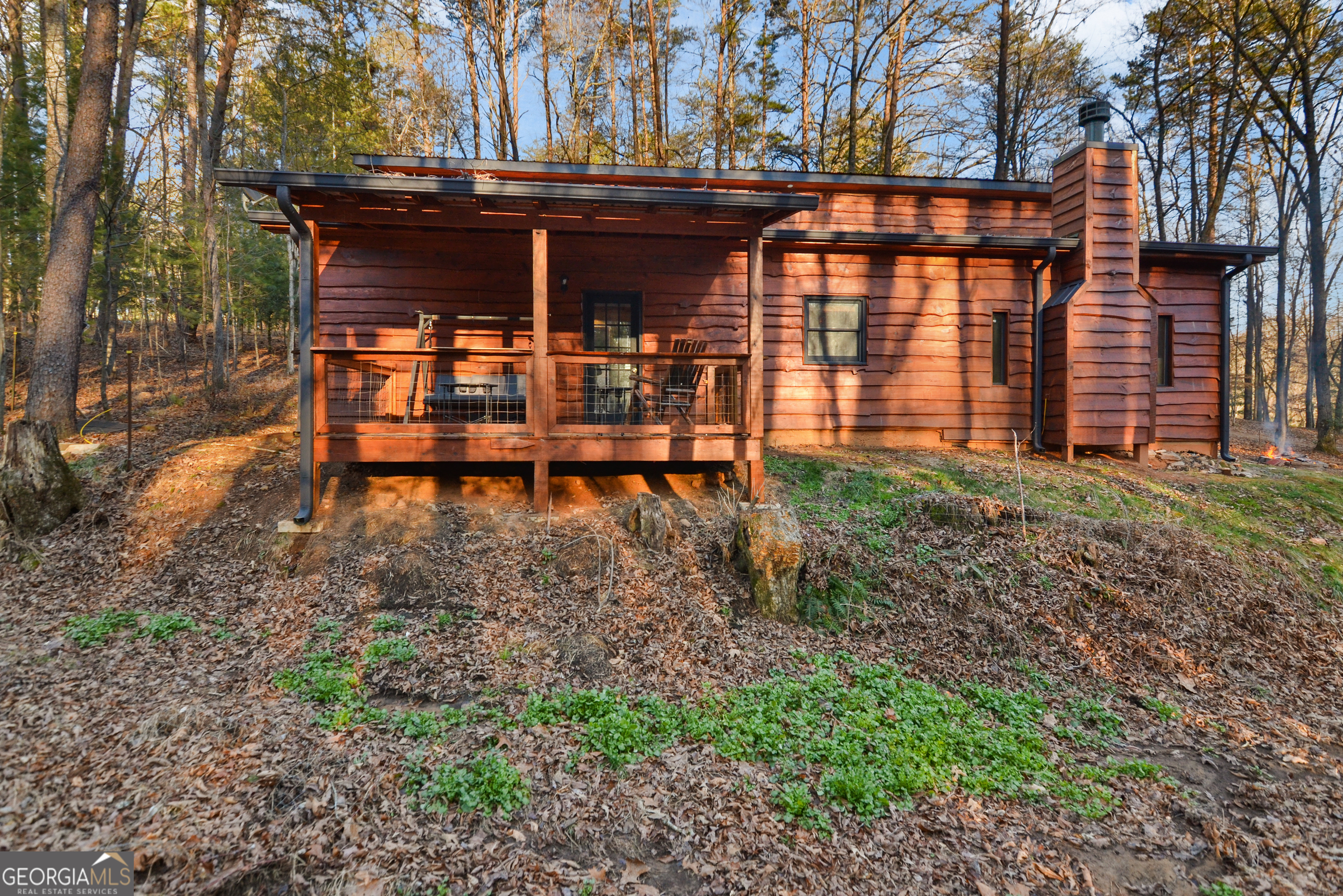 a backyard of a house with table and chairs