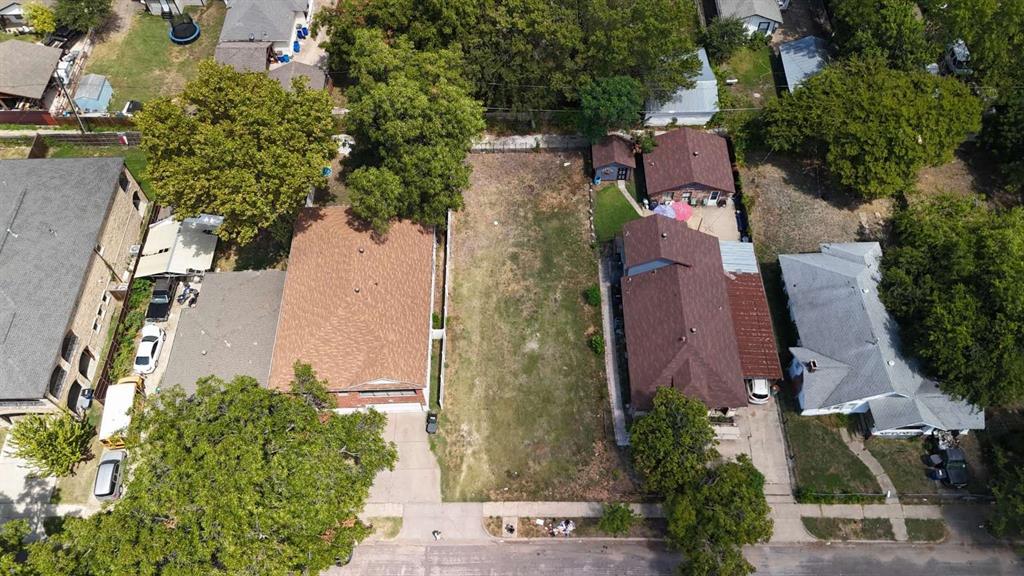 an aerial view of a house with outdoor space and street view