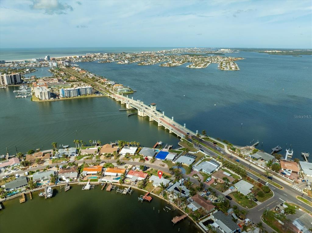 an aerial view of ocean and residential houses with outdoor space