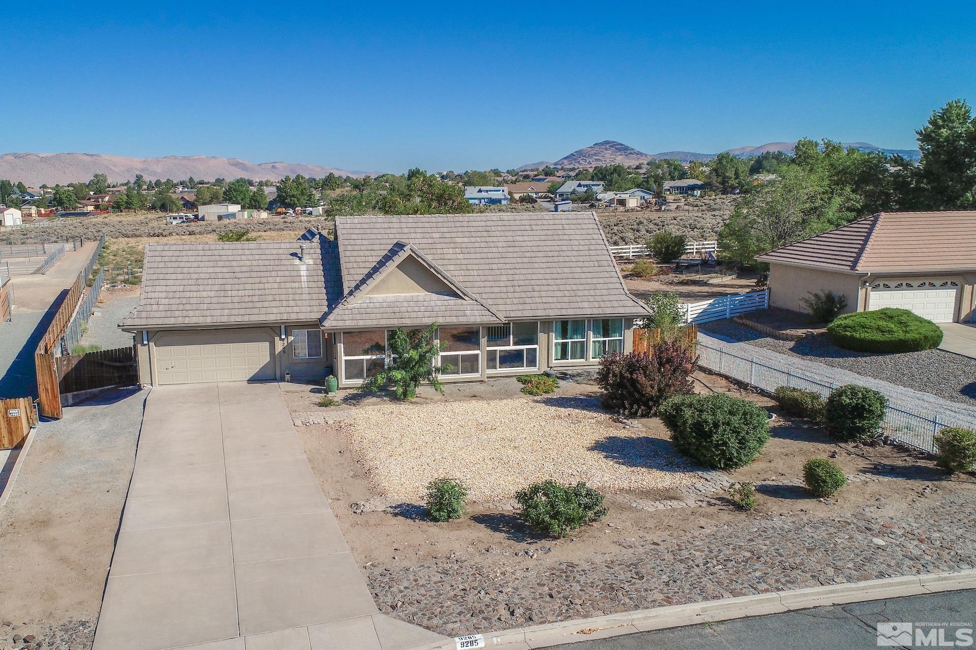 an aerial view of a house with a yard and lake view