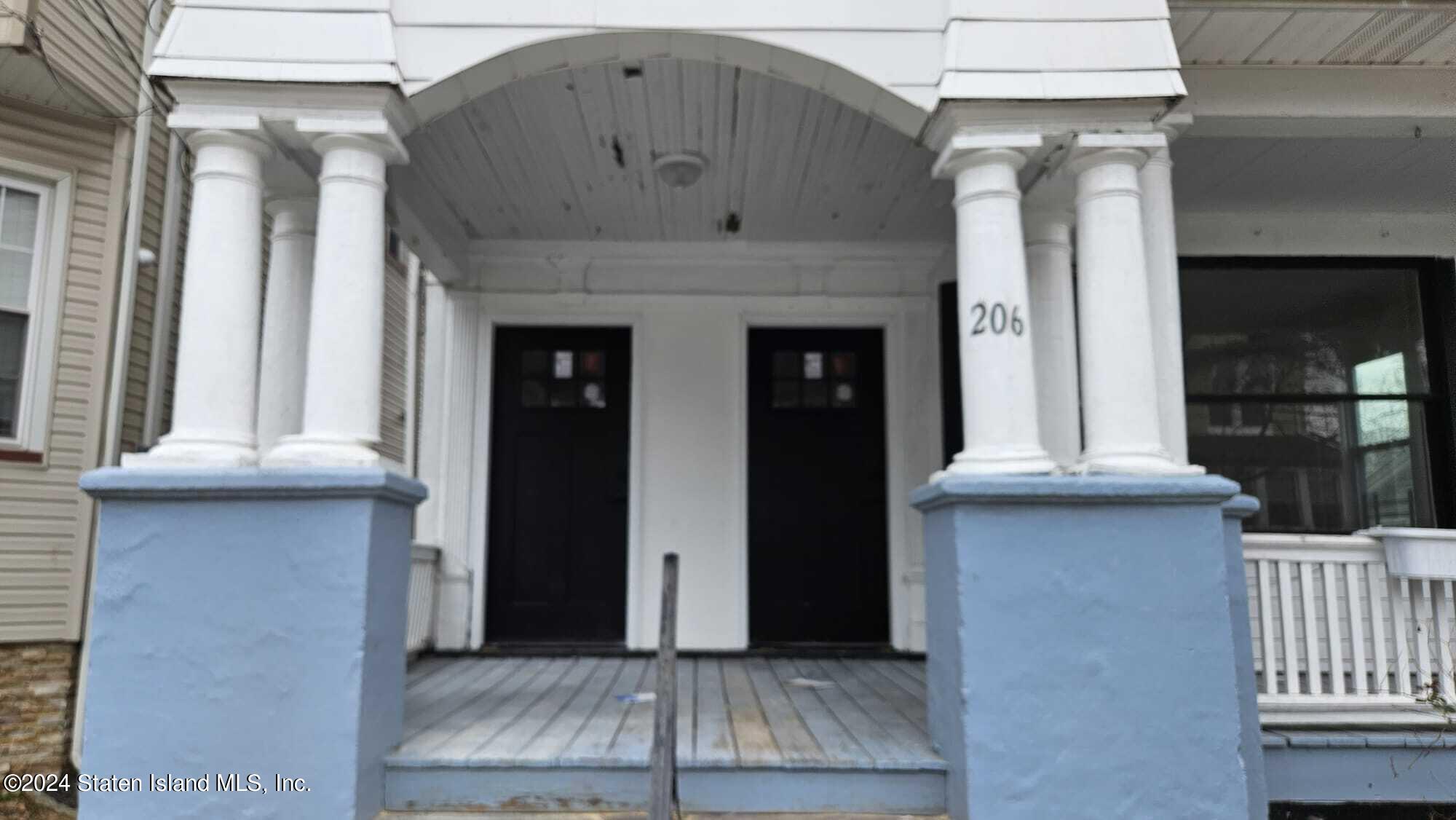 a view of a house with a door and wooden floor