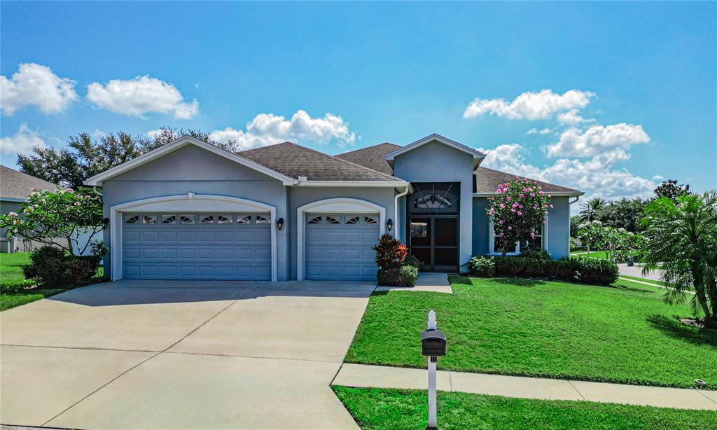 a front view of a house with a yard and garage