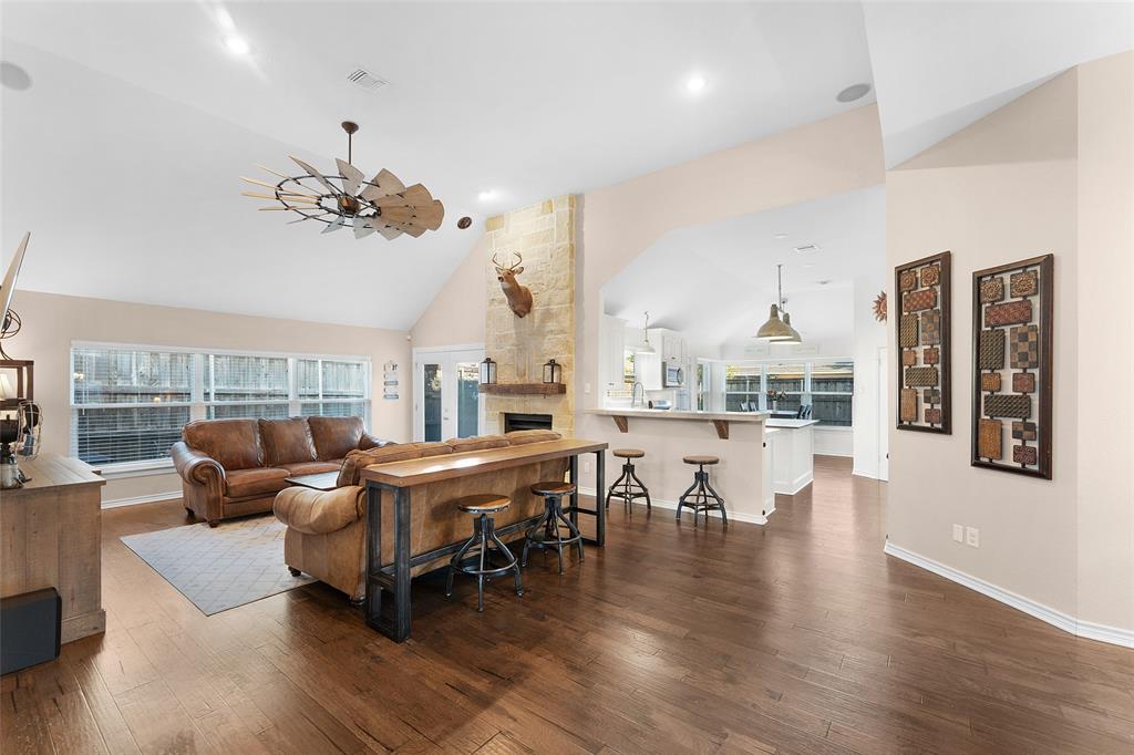 a living room with fireplace furniture and a wooden floor