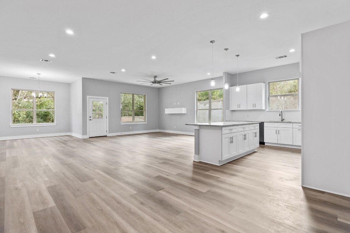 a large kitchen with stainless steel appliances granite countertop a large center island and a window