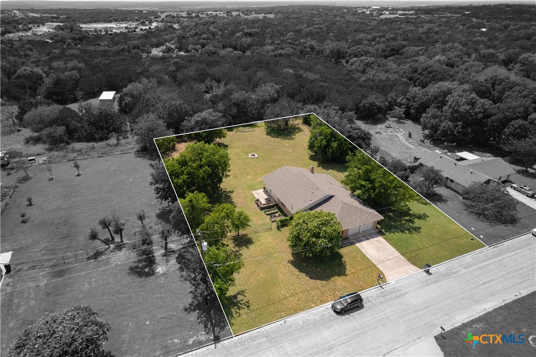 an aerial view of house with a yard