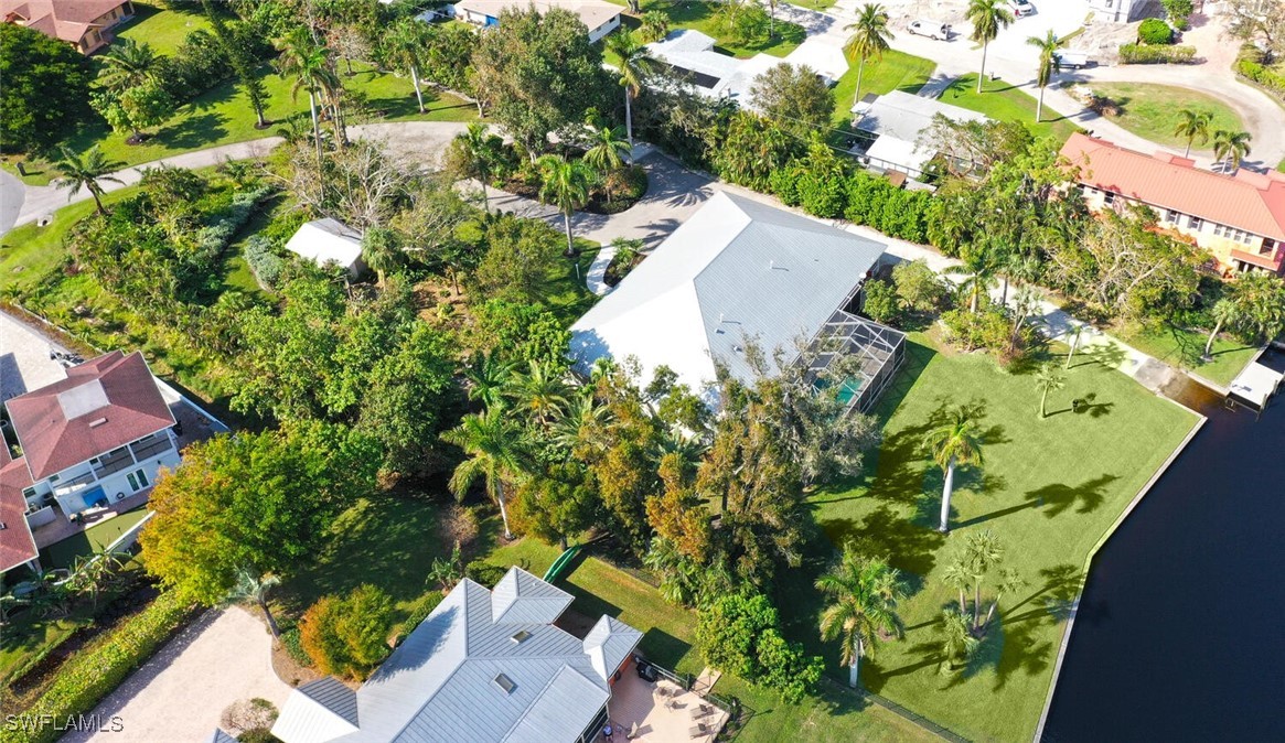 an aerial view of a house with a yard and garden