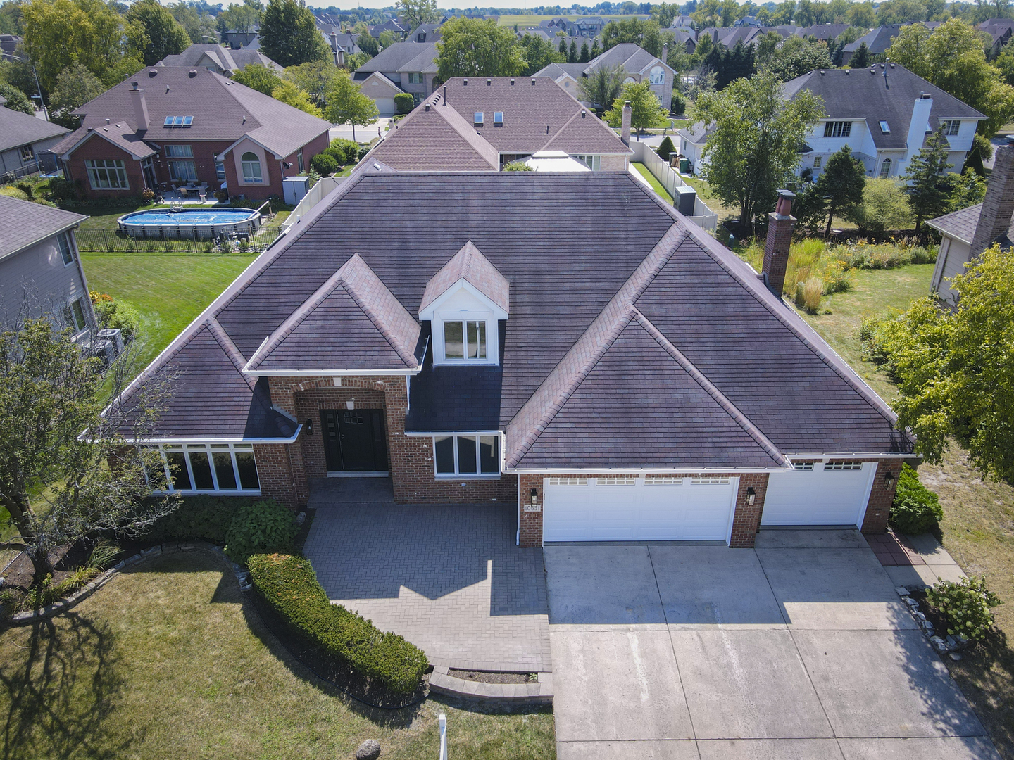 an aerial view of house with yard and mountain view in back