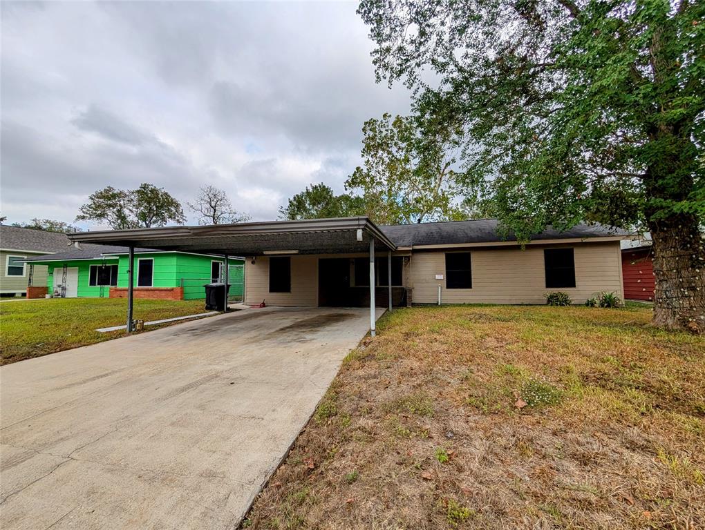 a front view of house with yard and trees around