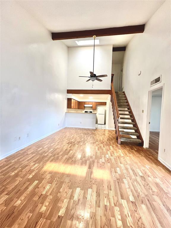 a view of a room with wooden floor and stairs