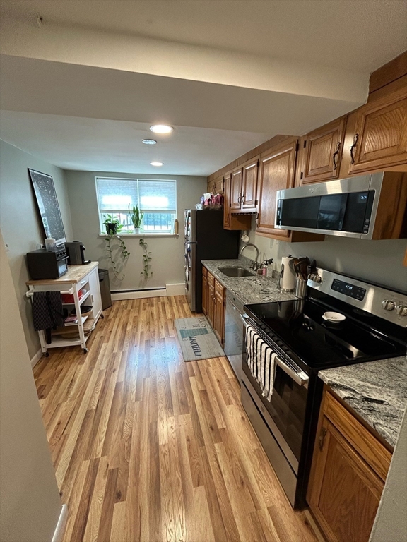 a kitchen with granite countertop a stove and a sink