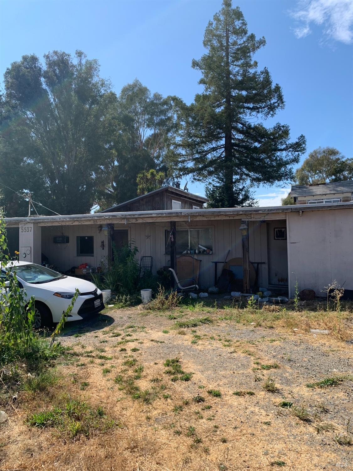 a backyard of a house with yard and barbeque oven