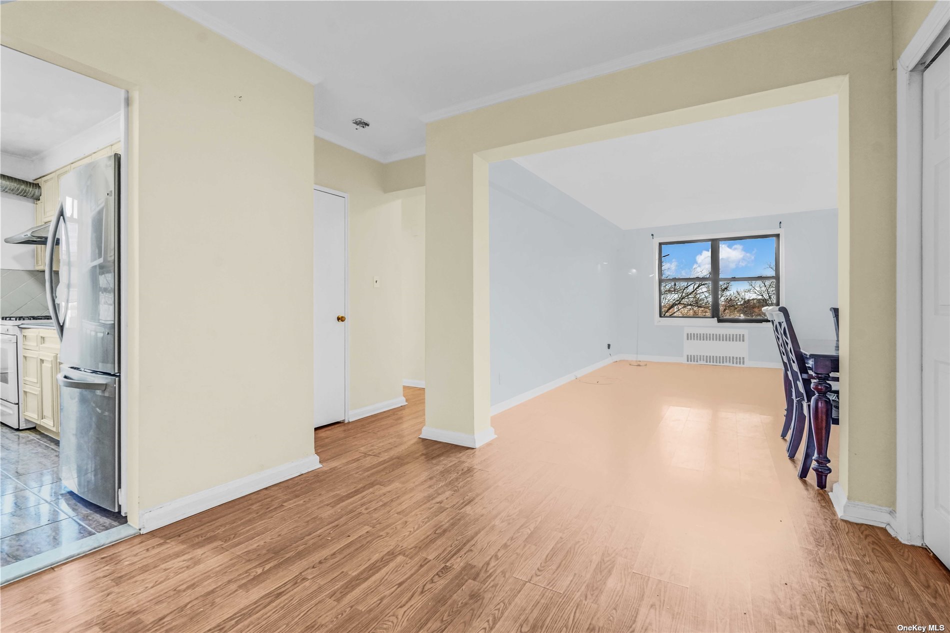 a view of empty room with wooden floor