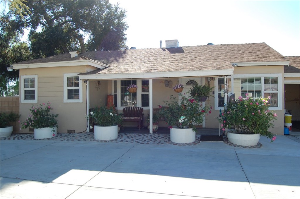 a view of a house with potted plants and a potted plant