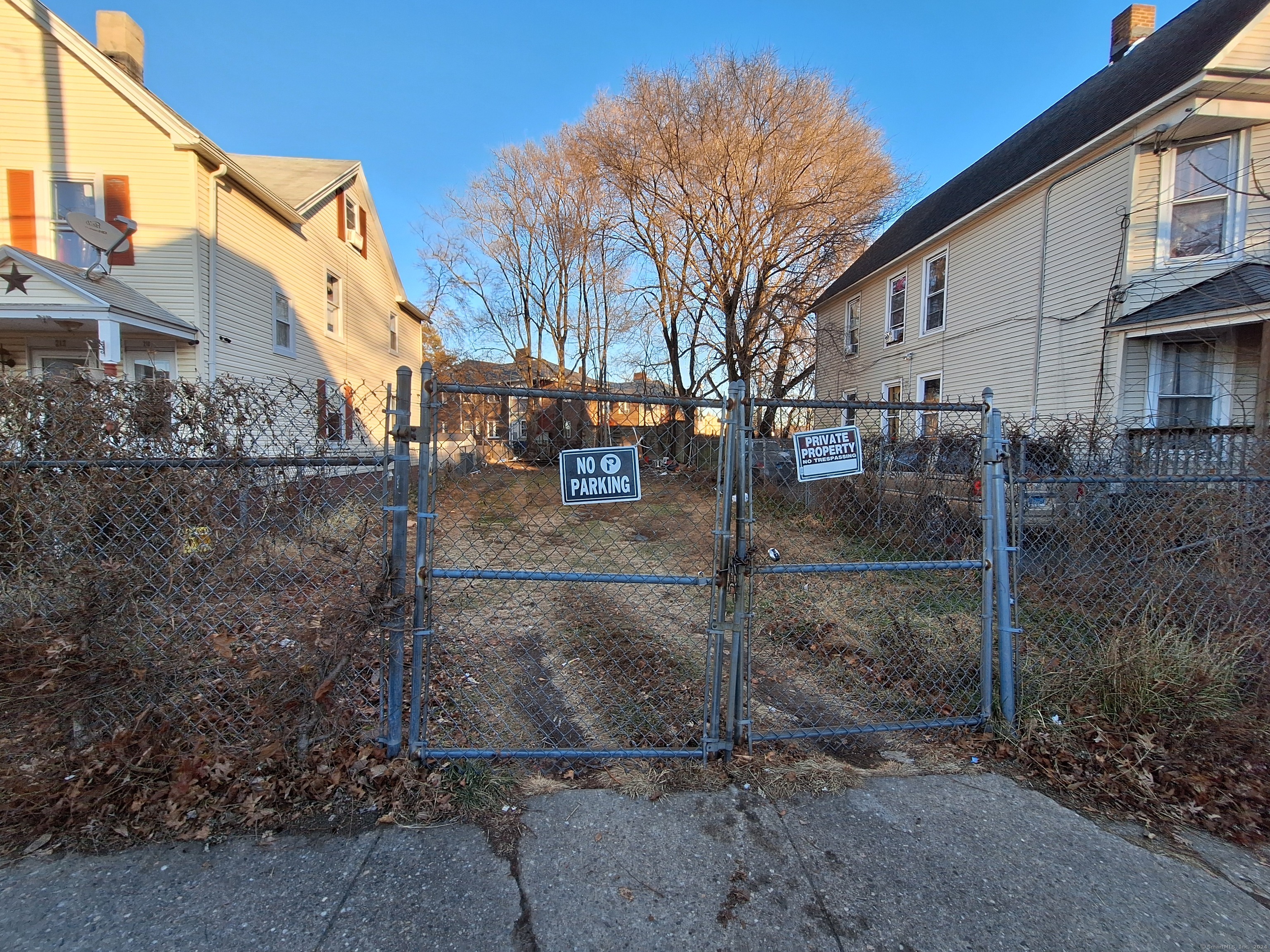 a view of a white house with a yard