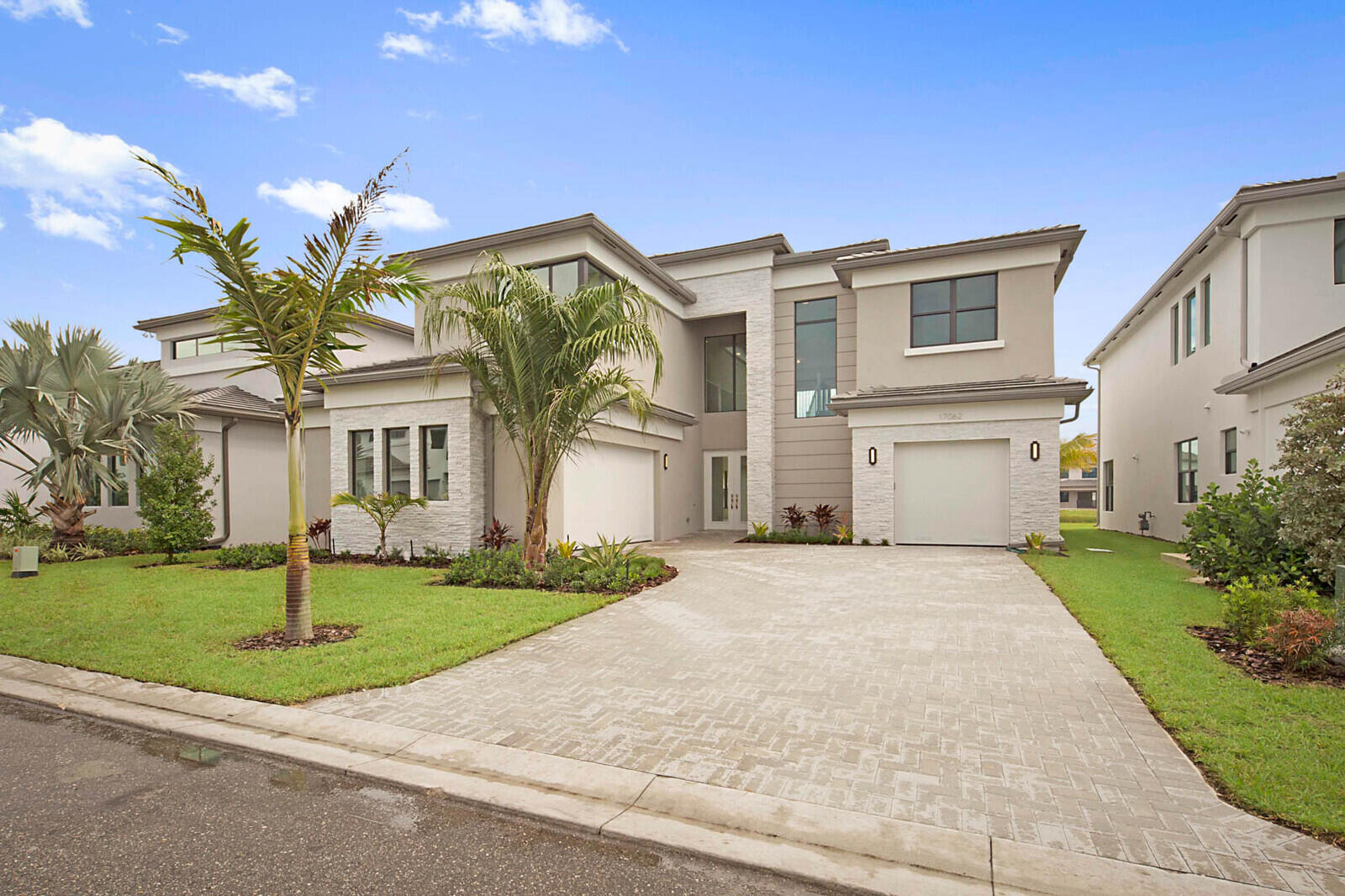 a front view of a house with a garden and yard