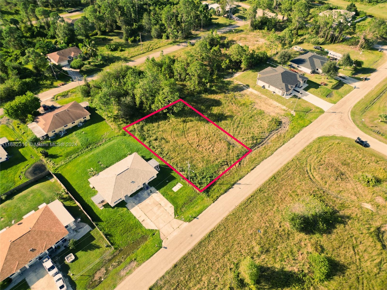 an aerial view of residential houses with yard