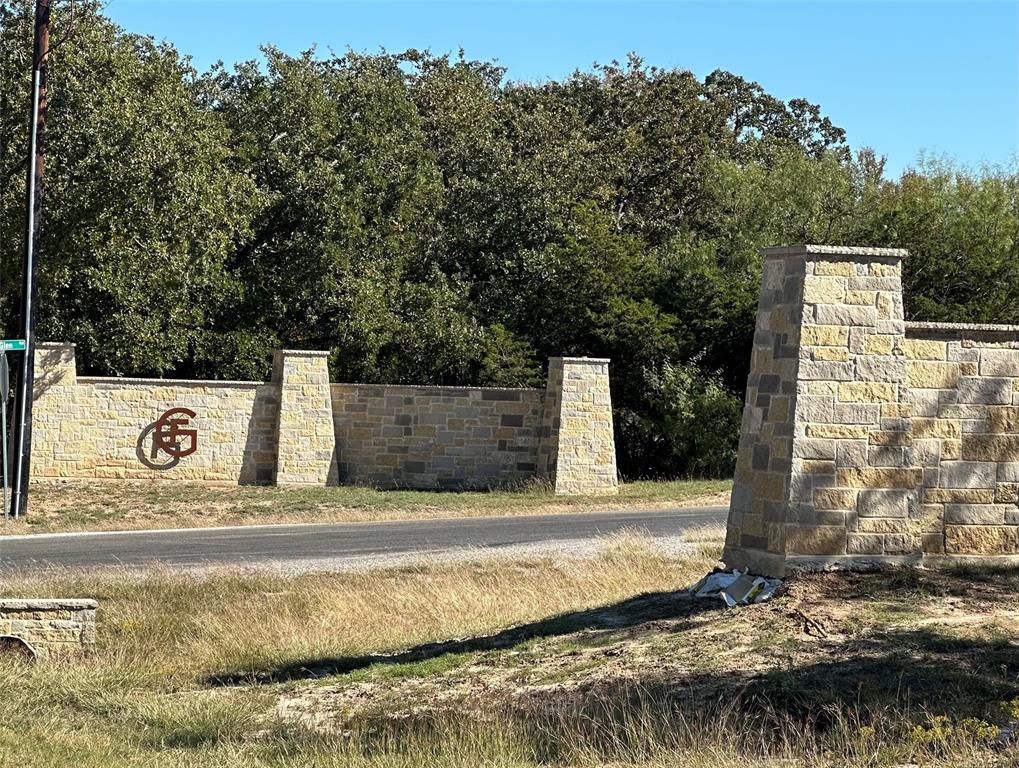 a street sign under a large tree