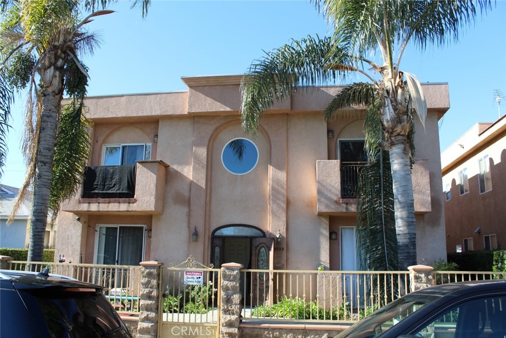 a front view of a house with a tree